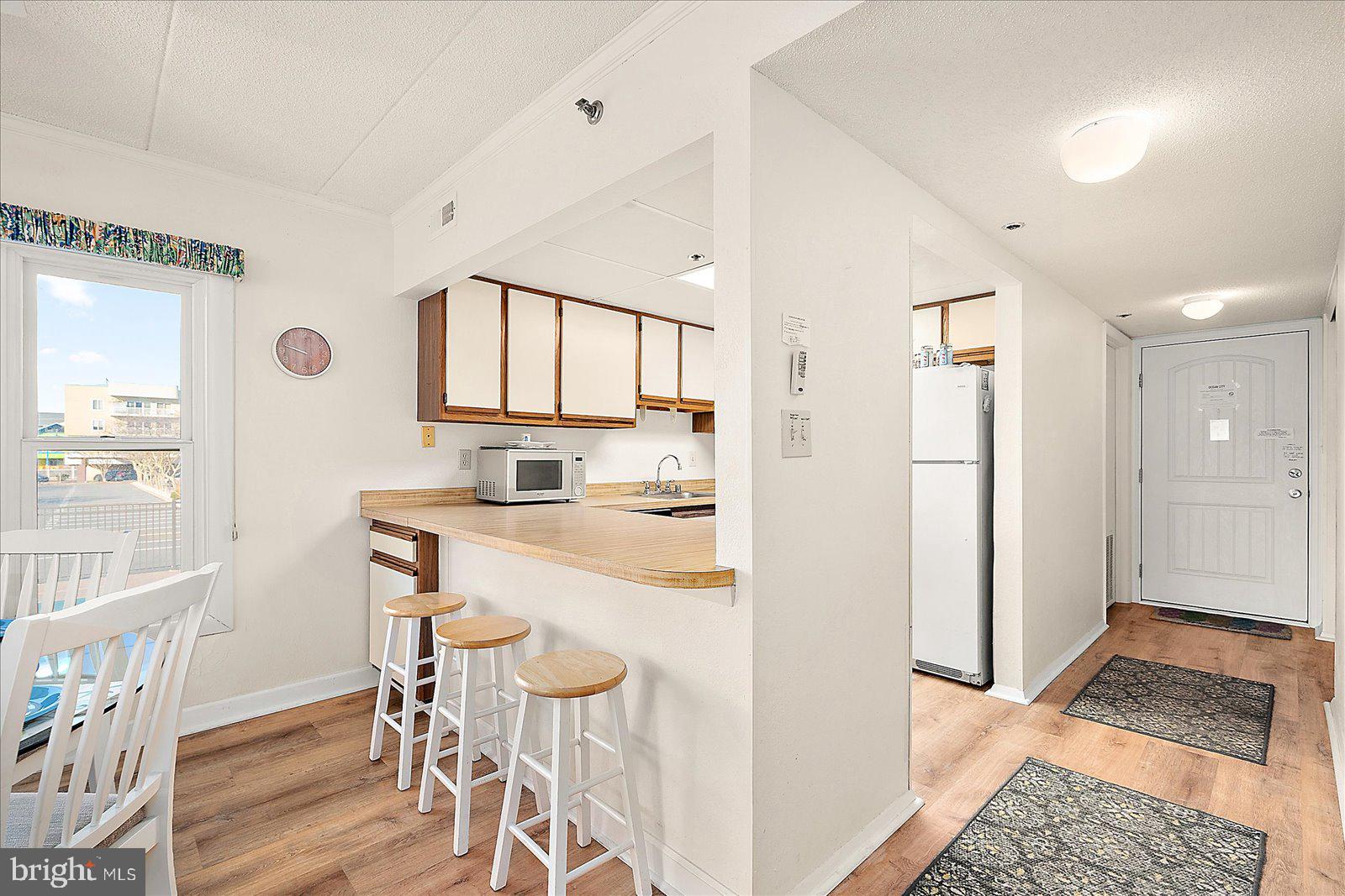 5801 Atlantic Avenue, Unit 101 Ocean City, MD 21842 - Photo 15 of 50 a kitchen with stainless steel appliances granite countertop a refrigerator and a stove top oven