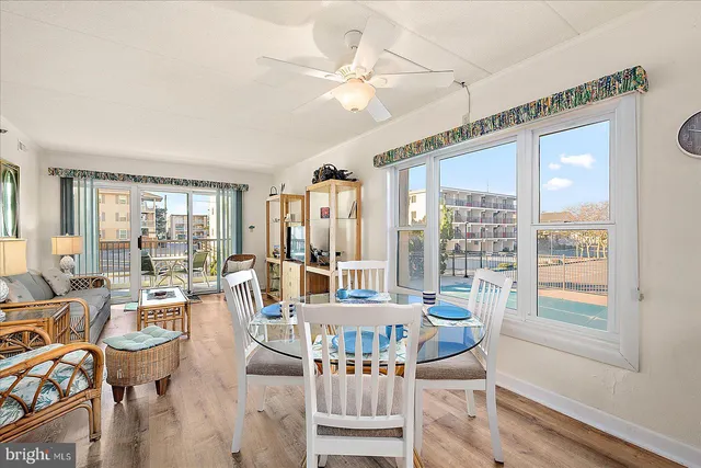 a living room with fireplace furniture and a large window