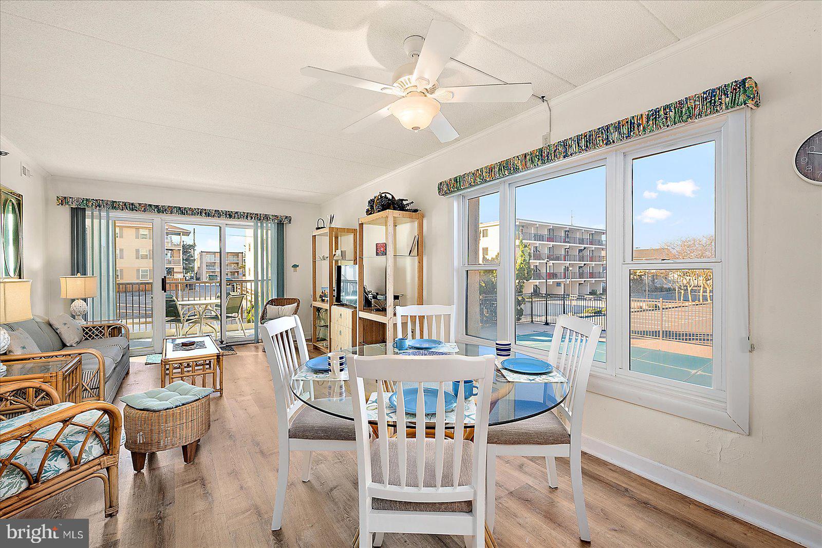 5801 Atlantic Avenue, Unit 101 Ocean City, MD 21842 - Photo 16 of 50 a living room with fireplace furniture and a large window