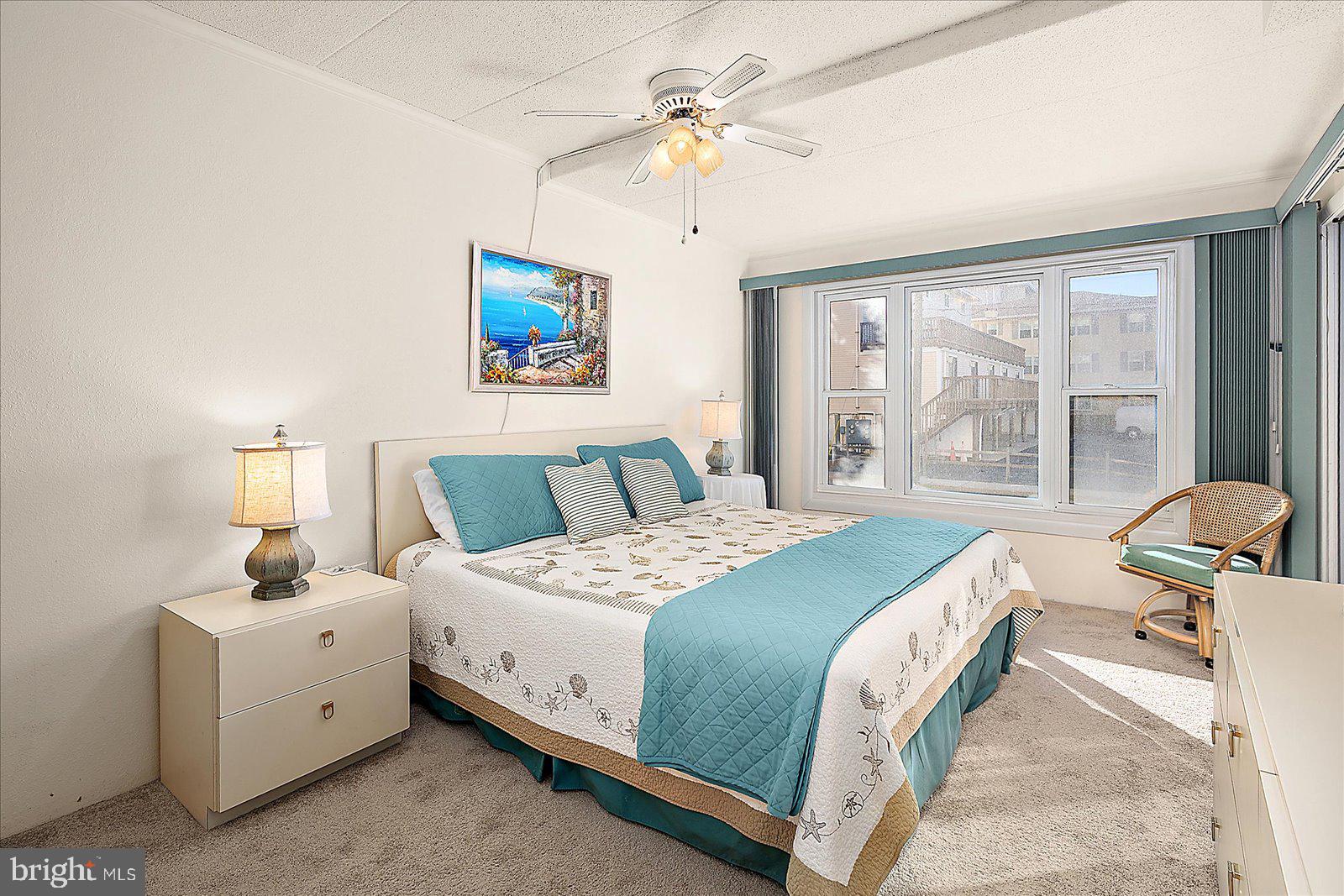 5801 Atlantic Avenue, Unit 101 Ocean City, MD 21842 - Photo 19 of 50 a bedroom with a bed and a large window