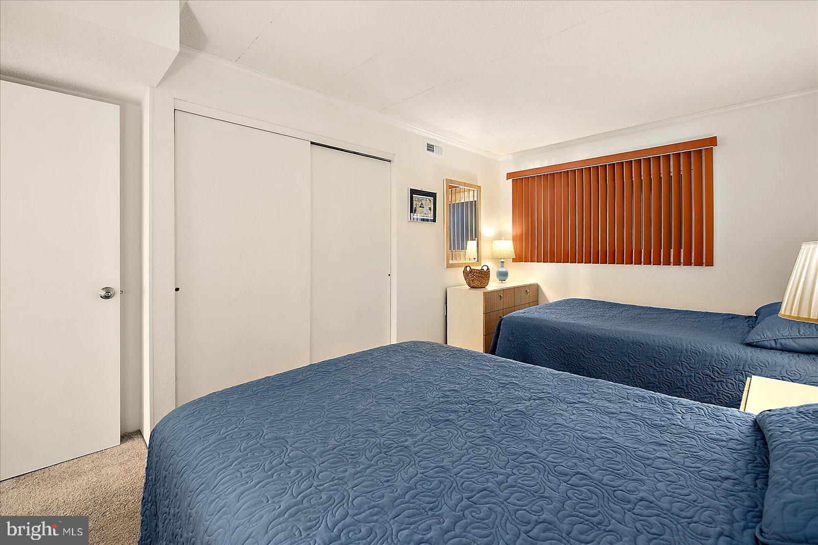 5801 Atlantic Avenue, Unit 101 Ocean City, MD 21842 - Photo 24 of 50 a bedroom with a bed and a dresser