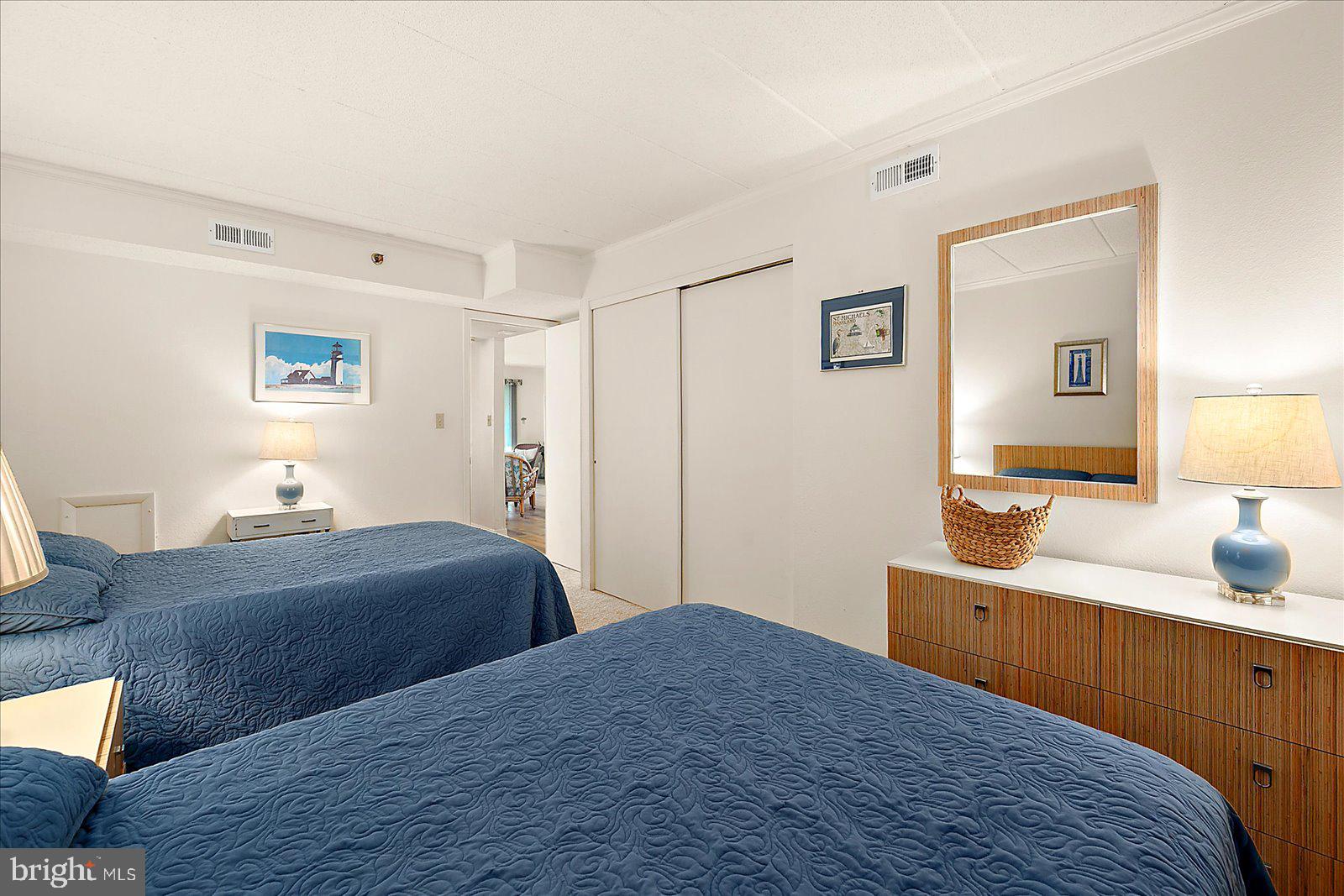 5801 Atlantic Avenue, Unit 101 Ocean City, MD 21842 - Photo 25 of 50 a bedroom with a bed and a dresser