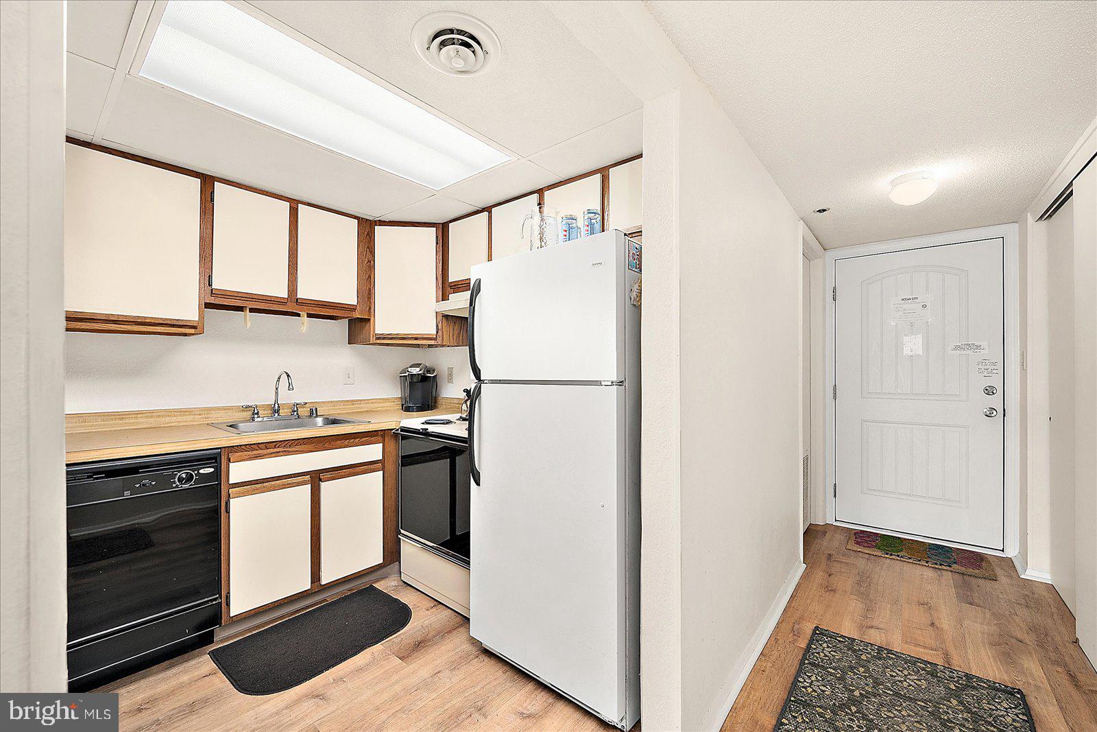 5801 Atlantic Avenue, Unit 101 Ocean City, MD 21842 - Photo 3 of 50 a kitchen with stainless steel appliances granite countertop a refrigerator and a sink