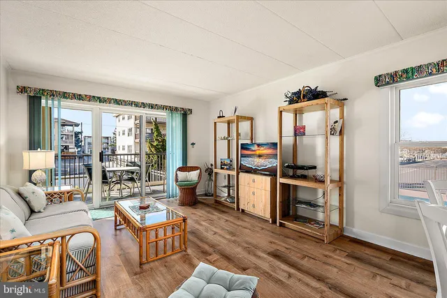 a living room with furniture and a kitchen view