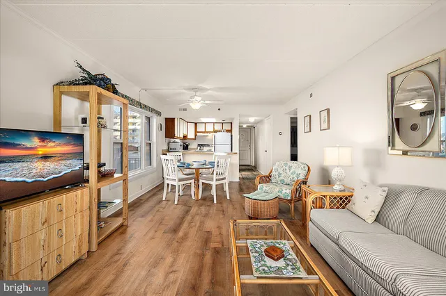 a living room with furniture flat screen tv and a table