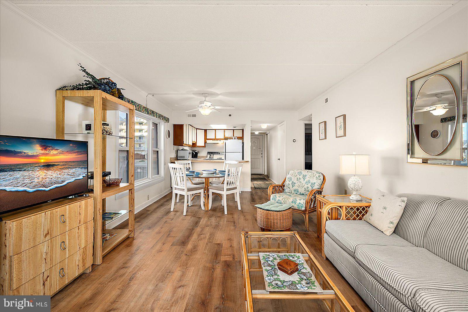 5801 Atlantic Avenue, Unit 101 Ocean City, MD 21842 - Photo 10 of 50 a living room with furniture flat screen tv and a table