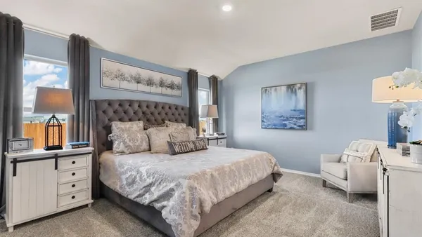 a bedroom with a bed and a night stand