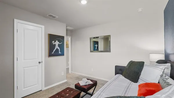 a bedroom with a bed and the view of hallway