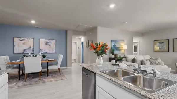 a kitchen with granite countertop a sink and dishwasher a dining table with garden view
