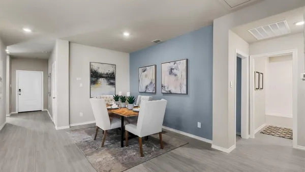 a dining room with furniture and wooden floor