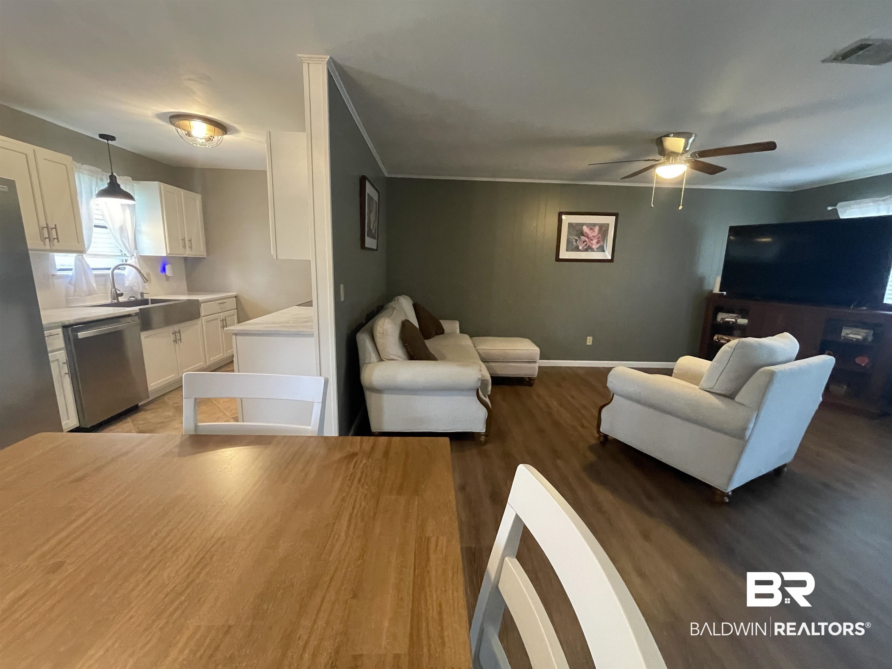 2274 Foshee Road Brewton, AL 36426 - Photo 7 of 23 Living area featuring wood finished floors, a ceiling fan, and ornamental molding
