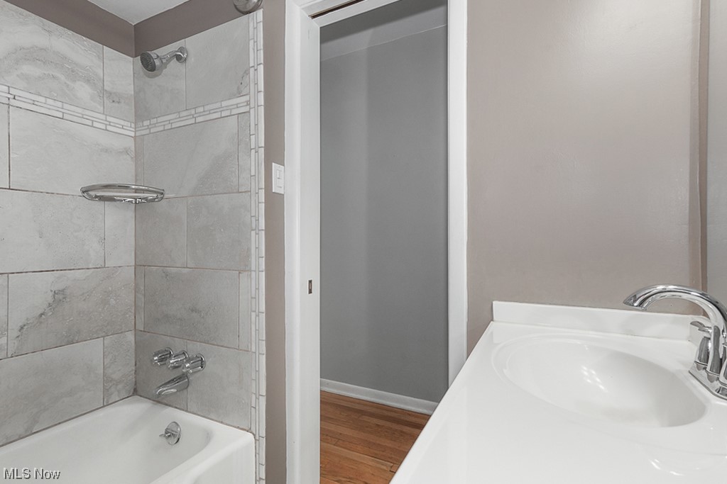 6456 Longridge Road Cleveland, OH 44124 - Photo 17 of 31 Bathroom featuring vanity, hardwood / wood-style flooring, and tiled shower / bath