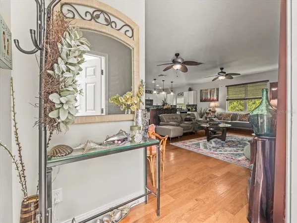 a view of a dining room with furniture a chandelier and wooden floor