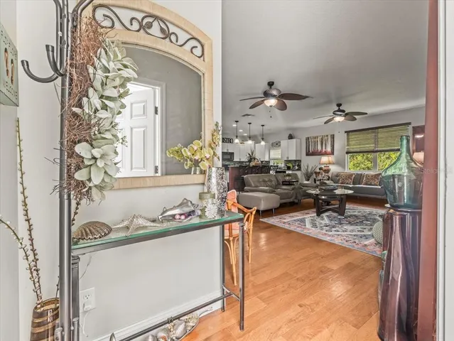 a view of a dining room with furniture a chandelier and wooden floor