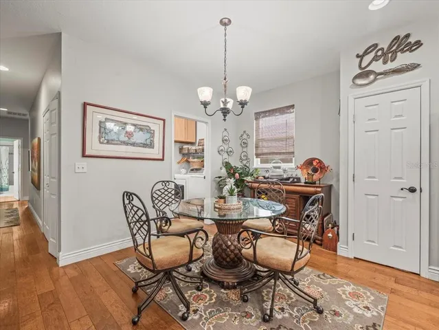 a kitchen with stainless steel appliances kitchen island a table and chairs