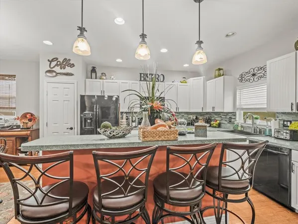 a kitchen with stainless steel appliances a stove microwave and refrigerator