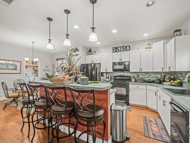 a kitchen with stainless steel appliances granite countertop a stove and a microwave