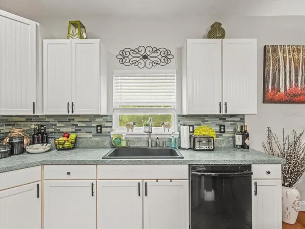 a large kitchen with kitchen island a sink table and chairs