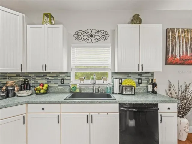 a large kitchen with kitchen island a sink table and chairs