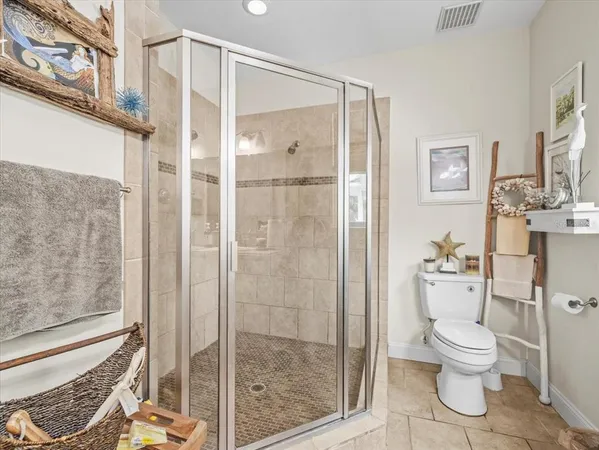 a view of a hallway with wooden floor and entryway