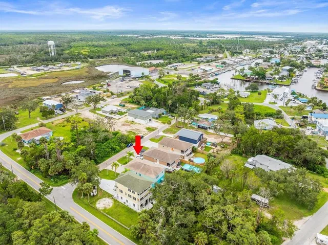 an aerial view of residential houses with outdoor space and swimming pool