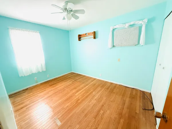 a view of a room with a wooden floor and entryway