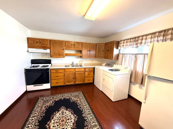 a kitchen with a white cabinets and white appliances