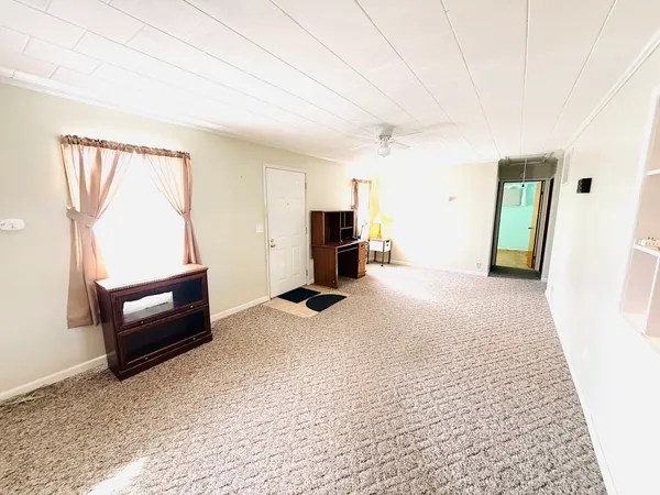 a bedroom with furniture and a window