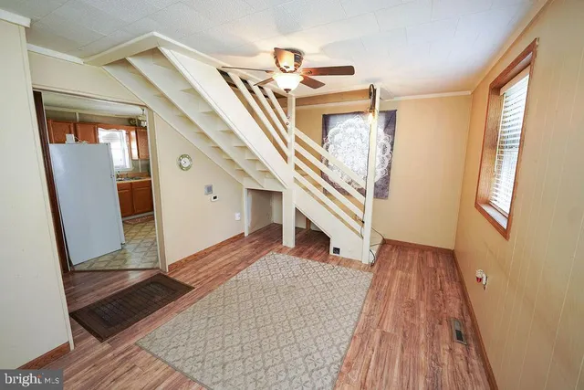 a view of entryway and hall with wooden floor
