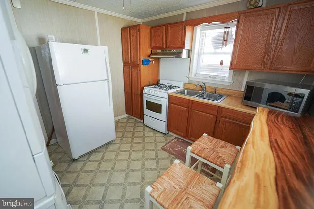 a kitchen with stainless steel appliances a refrigerator sink and cabinets