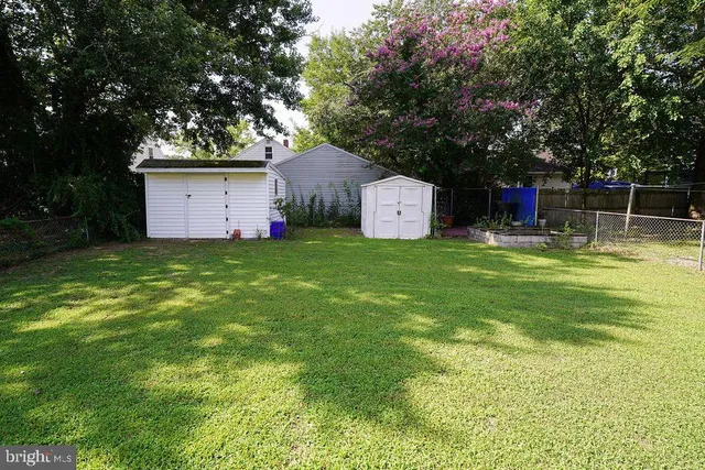 a view of a house with a yard and sitting area