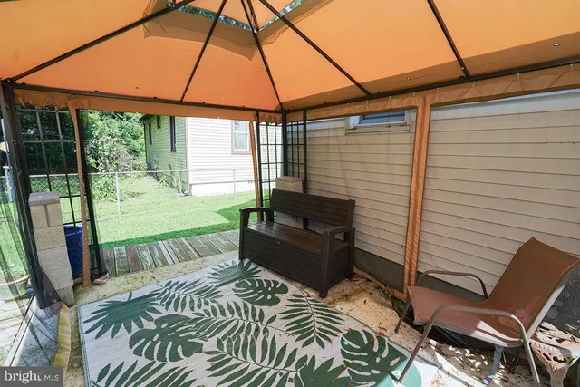 a backyard of a house with outdoor seating