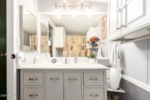 a bathroom with a double vanity sink mirror and