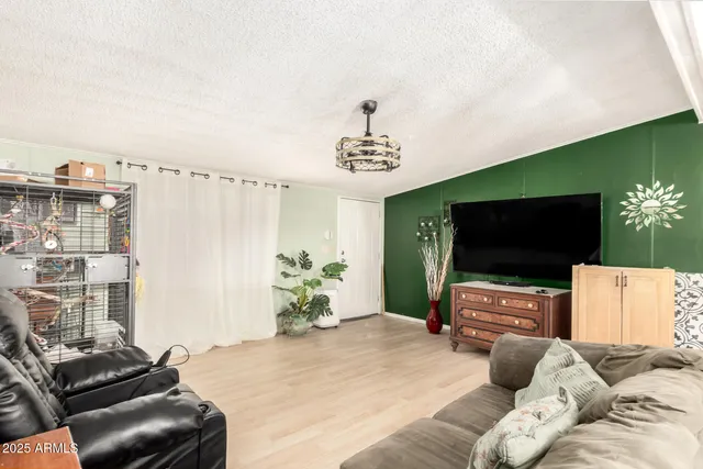 a bedroom with furniture and a flat screen tv