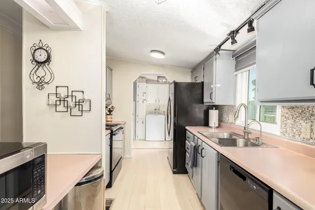 a kitchen with stainless steel appliances granite countertop a sink stove and refrigerator