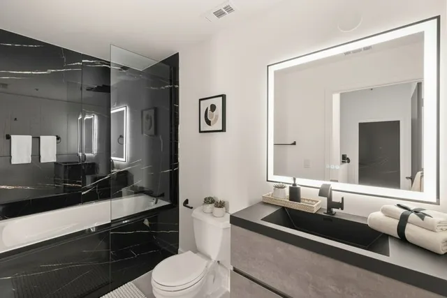 a bathroom with a sink a mirror and a toilet