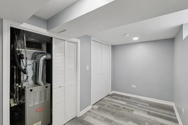 a view of a hallway with closet and a bathroom