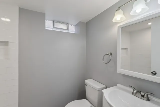 a white toilet sitting next to a bathroom sink