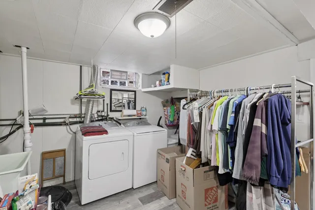 a view of walk in closet with clothes and shoes