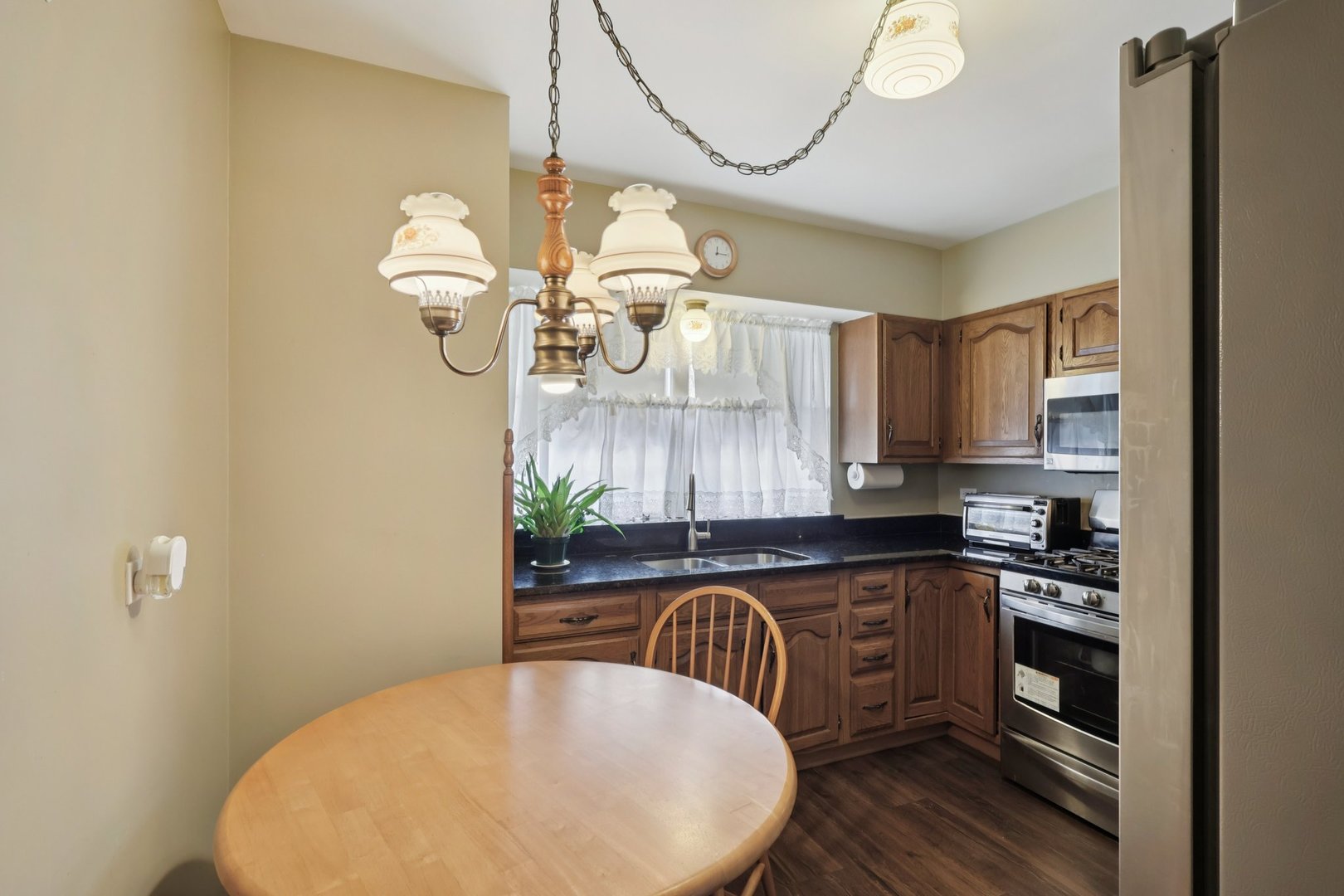 1034 31st Avenue Bellwood, IL 60104 - Photo 4 of 30 a kitchen with a table chairs and a chandelier