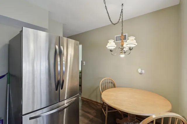 a view of a dining room with furniture wooden floor and a chandelier