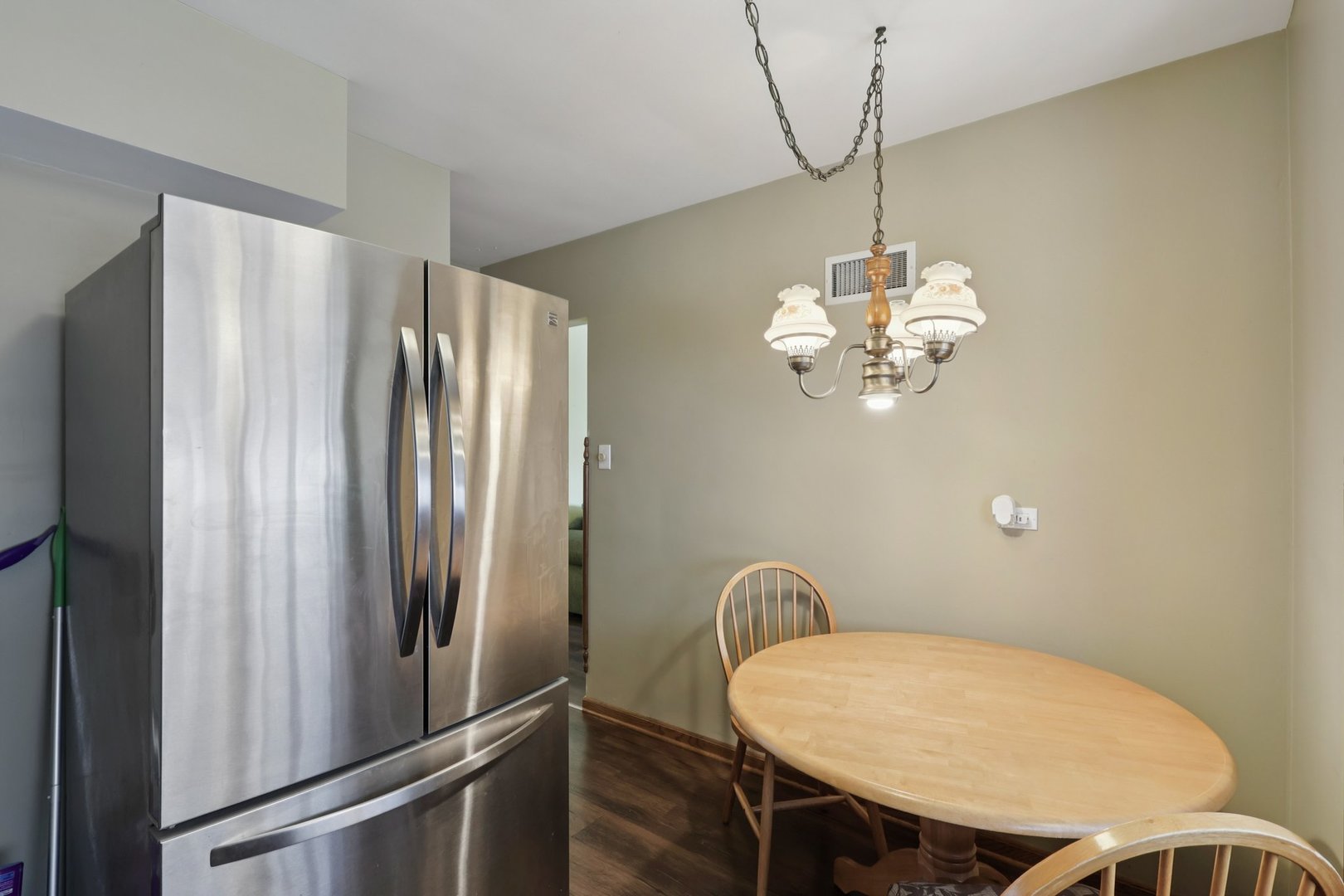 1034 31st Avenue Bellwood, IL 60104 - Photo 6 of 30 a view of a dining room with furniture wooden floor and a chandelier