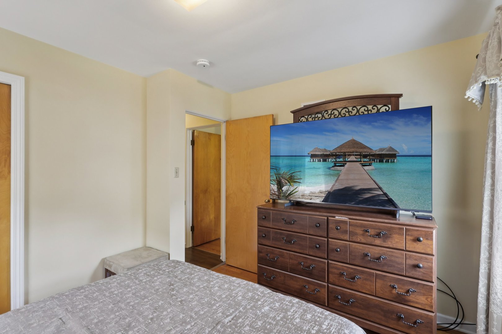 1034 31st Avenue Bellwood, IL 60104 - Photo 10 of 30 a room with a dresser and a wooden floor