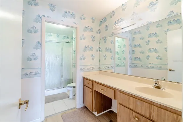 a bathroom with a glass shower door