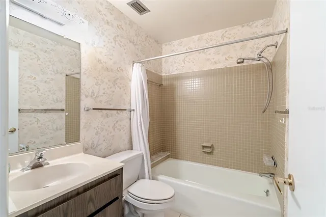 a kitchen with a refrigerator sink and white cabinets