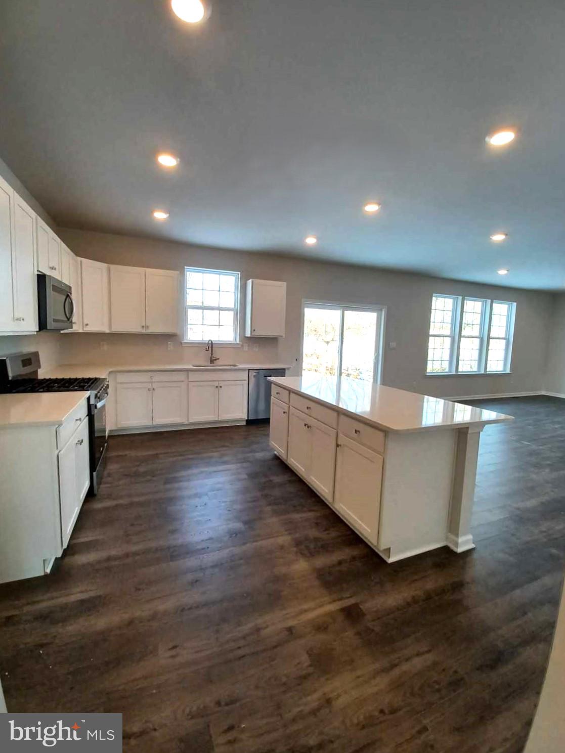 112 Winding Road Easton, PA 18040 - Photo 13 of 33 a large kitchen with kitchen island wooden floors and white cabinets