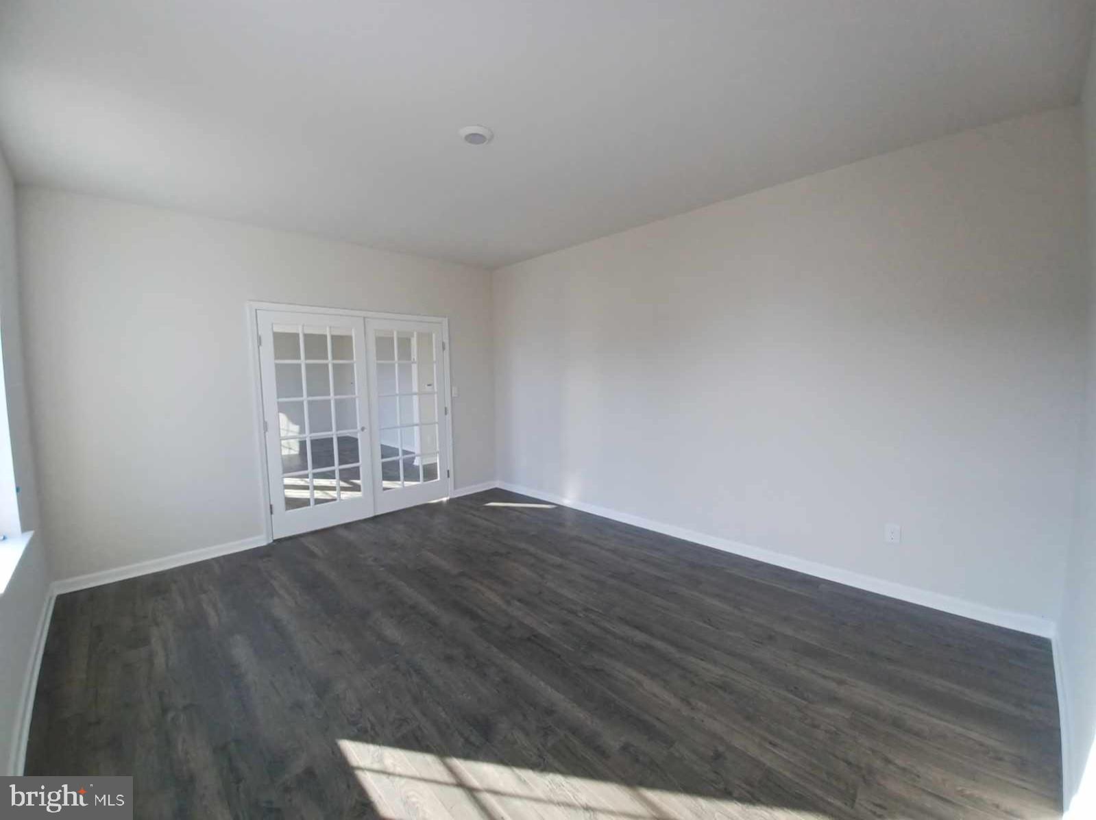 112 Winding Road Easton, PA 18040 - Photo 18 of 33 a view of an empty room with wooden floor and a window