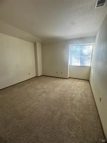 an empty room with a empty space and windows