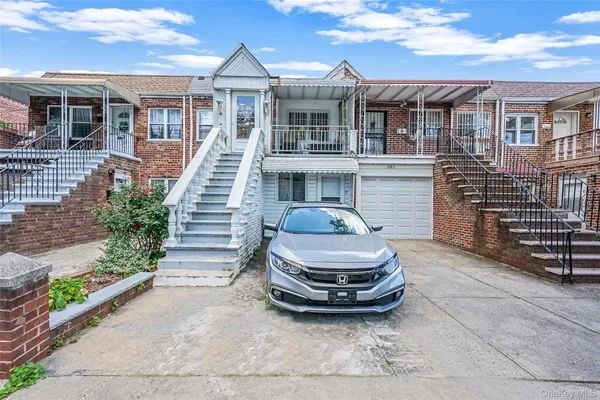 a front view of a house with a garden and outdoor seating