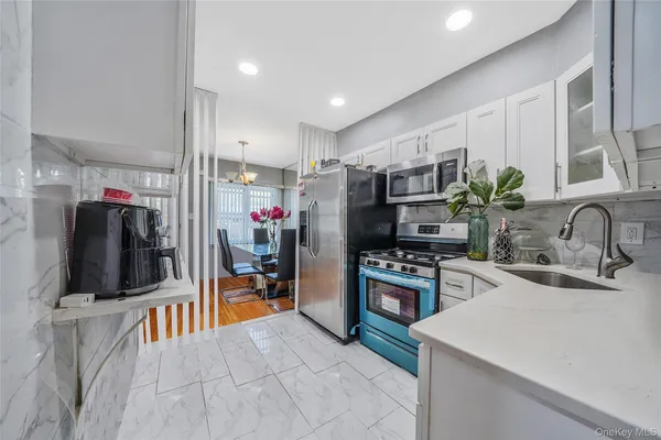 a kitchen with appliances a sink and cabinets